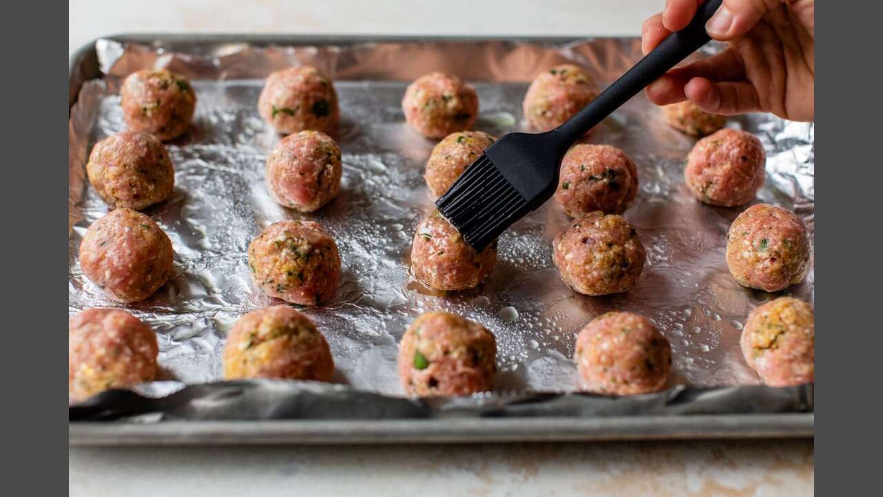 Shaping The Meatballs And Placing Them On A Baking Sheet