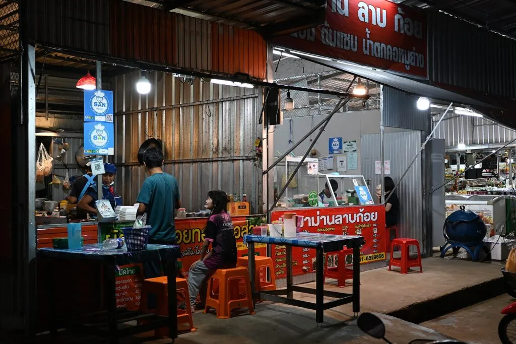 Street food stall with plastic stools