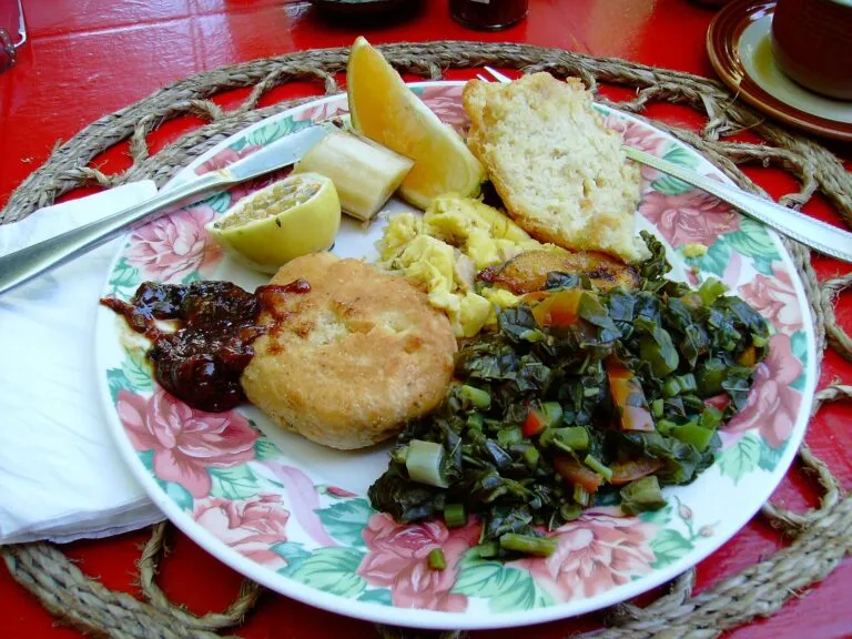 Jamaican breakfast of ackee and saltfish with callaloo and fried dumpling